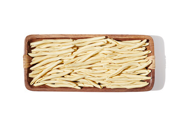 Maccheroni al Feretto noodle in wooden bowl isolated on white, close up