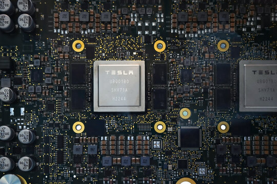 Honolulu, Hi - January 12, 2024: Tesla Artificial Intelligence full self driving autopilot brain semiconductor processor closeup on motherboard with circuits. Macro, selective focus.