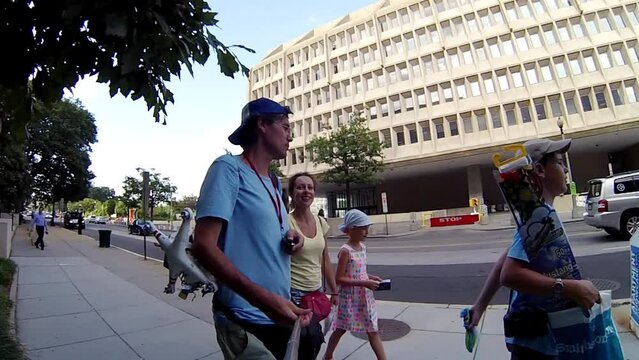 Family of four mr walk down street