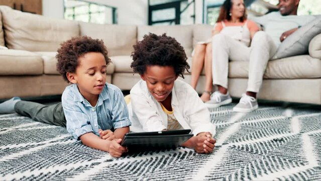 Black family, kids and siblings on a floor with tablet, search or streaming, cartoon or games at home together. Digital, love or children in living room on app for learning, ebook or video in a house