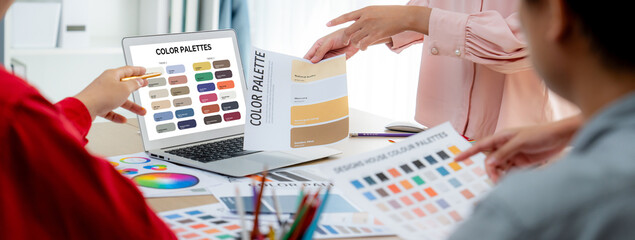 A portrait of creativity graphic designer team select appropriate color for the project by using...