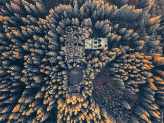 Ruins of former tin mine near Rolava village in the forests of Ore Mountains, Czech Republic. Aerial view from drone.