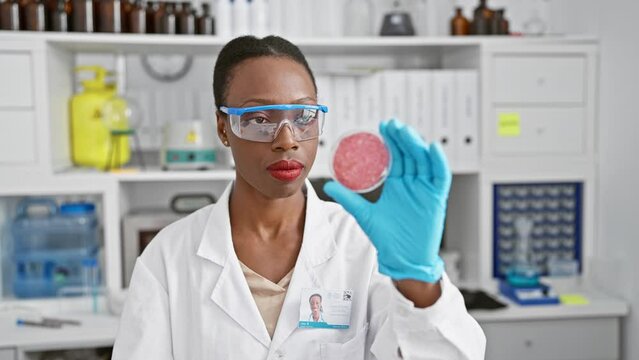 Serious african american woman scientist, fervently immersed in her work, poring over a crucial sample at the lab, encapsulating the strength of black, female professionals in science.