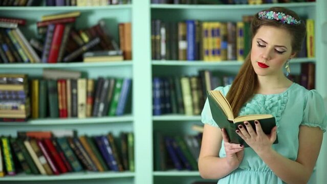 Young woman with jewelery on head read book in library
