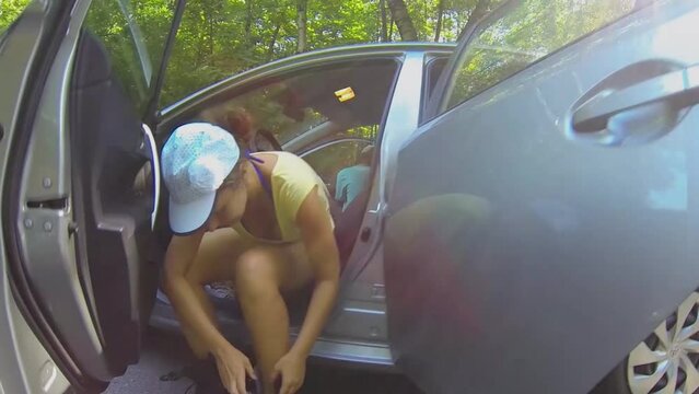 Little girl and her mother prepares to ride on rollerblades