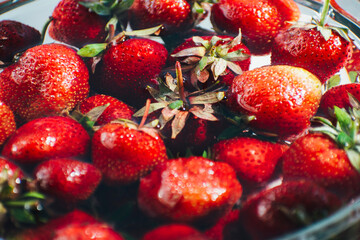 strawberries in a glass jar on the table. white background. Summer fruits. Seasonal fruits and vegetables. Vegetarian food. deliciously
