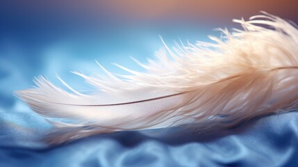 a close up of a white feather on a blue satin material with a blurry back drop of light in the background.