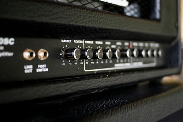 Close up electric guitar amplifier. Master regulator knob, volume level.