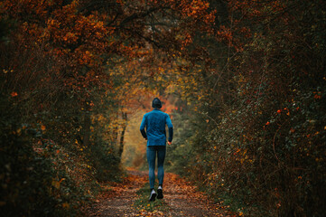 Young Trail Runner Gracefully Navigates Foggy Autumn Trails