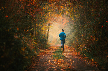 Captivating Photo of a Young Runner in Autumn Fog