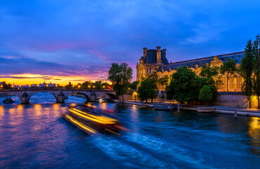 Sunset view of Seine river, Pont du Carrousel in Paris, France. Cityscape of Paris. Architecture...