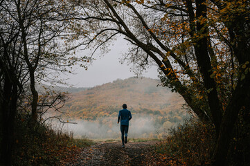 Young Trail Runner's Journey Through Autumn's Whispering Shroud