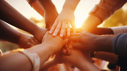 Emotion of connection, close-up image of diverse hands reaching for each other against a sunrise, symbolising unity in the face of global warming, - obrazy, fototapety, plakaty