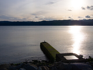 Storm Pipe Out To The River With A Bird On It At Sunset