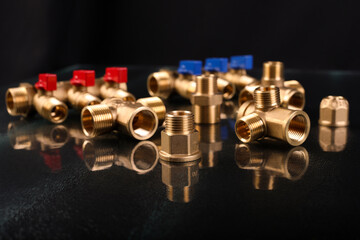 A set of metal and copper water pipe parts, a water wrench and pipe elbows, blue and red colors,...