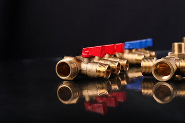 A set of metal and copper water pipe parts, a water wrench and pipe elbows, blue and red colors,...