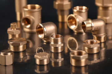 A set of metal and copper water pipe parts, a water wrench and pipe elbows, blue and red colors,...