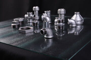 A set of metal and copper water pipe parts, a water wrench and pipe elbows, blue and red colors,...