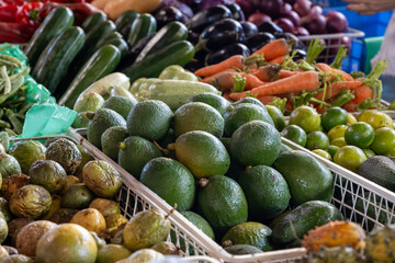 Fresh ripe green avocados, tropical fruits and vegetables on farmers market on Fuerteventura, Canary islands, Spain