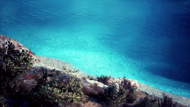 The limestone coast of the cliffs meets the warm turquoise waters