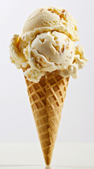 A close-up image of vanilla ice cream melting over a crispy waffle cone with bits of nuts.