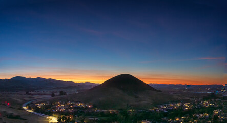 Panorama sunrise, sunset with hilltop silhouetted with light