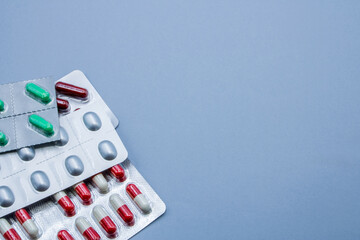 Blister of medicines on a blue background with space for text