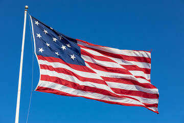 USA Flag Waving in Blue Background. Clear Blue Sky. American Wave Flag