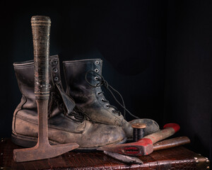 Old leather work boots and ax