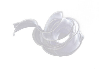 White ribbon long straight fly in air with curve roll shiny. White snow ribbon for present gift birthday party to wrap around decorate, curl curve long straight. Black background isolated