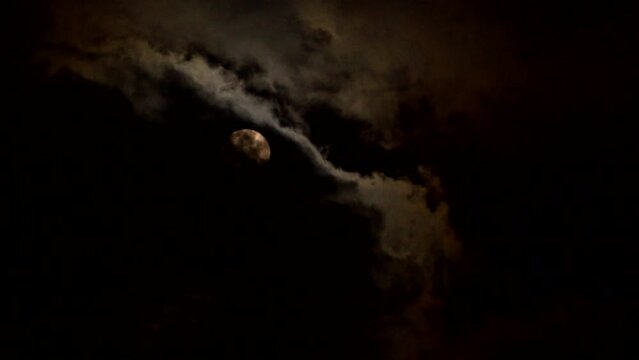 Full moon with dark cloud in the night, countryside Chiangmai province  Thailand