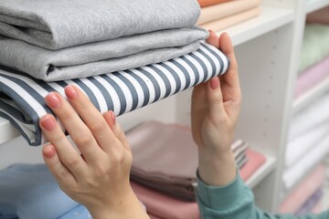 Customer choosing bed linens in shop, closeup