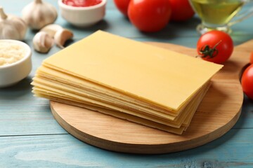 Ingredients for lasagna on blue wooden table, closeup