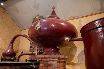 Double distillation process of cognac spirit in Charentias copper still pots and boilers in...