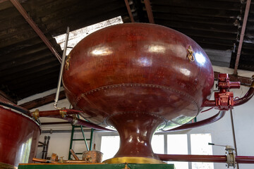 Double distillation process of cognac spirit in Charentias copper still pots and boilers in...