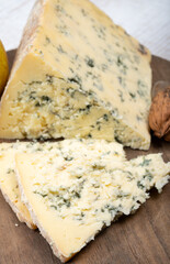 Cheese collection, English semi-soft, crumbly old stilton blue cheese close up