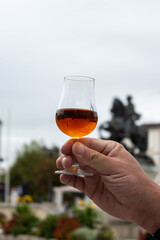 Tasting of cognac alcohol drink and view on old streets and houses in town Cognac, Grand Champagne,...