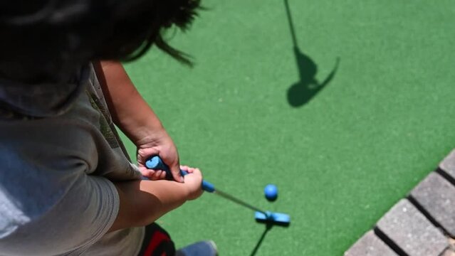 golf, sport, ball, grass, green, game, lawn, bowls, play, bowling, croquet, playing, leisure, boy, golfer, club, fun, hole, woman, outdoor, player, recreation, people, competition, child