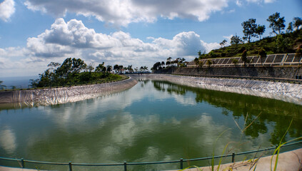 A reservoir on a hill which functions as irrigation as well as a refreshing place