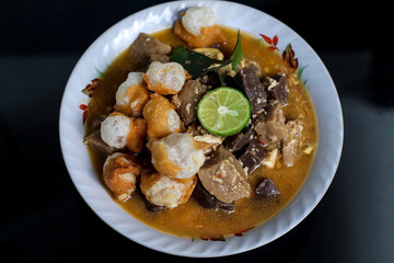 Traditional Indonesian food spicy and savory Seblak Jeletot, with toppings of wet crackers, meatballs, chicken, etc. Cooked with spicy sauce, from Sunda, West Java.