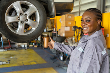 Young female customer with automotive mechanic worker, thumb ups and happy smiles in quality at maintenance garage, check and repair auto industry. Selective Focus