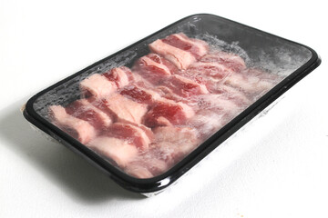 Sliced raw beef isolated on a white background