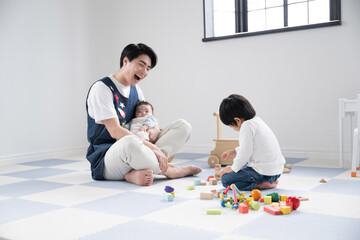 Male childcare worker playing with children at a daycare center. For images such as job hiring career change.