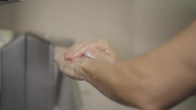 Doctor sanitizing hands before a surgical procedure.