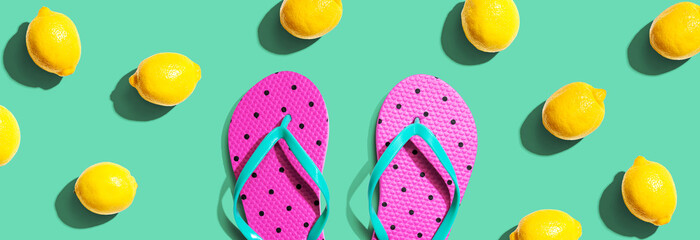Summer concept with flip flops and lemons - flat lay