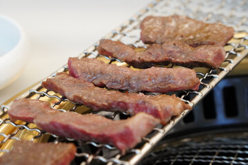 Beef is grilled on charcoal