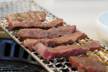 Beef is grilled on charcoal