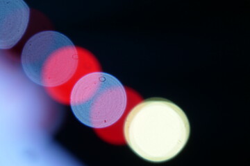 diagonal blur event lights with white, red and yellow tones on a black background