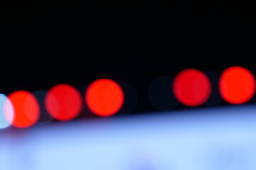lights with a red blur effect at night with a dark background