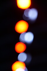 colorful lights blurred lights background with bokeh effect with white and orange colors